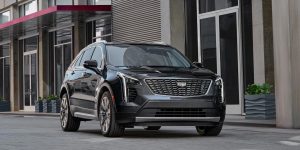 A black 2022 Cadillac XT4 parked in front of a store.