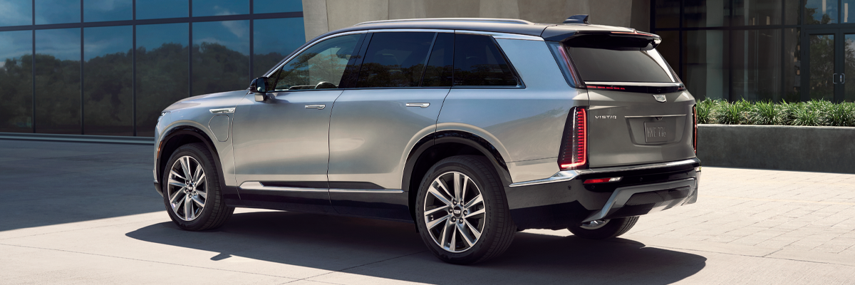 Three-quarters Rear View of the Cadillac VISTIQ Parked Outside of a Modern Building