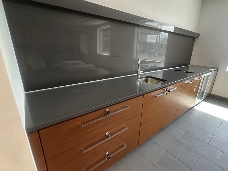 New refreshment counter with wood cabinets and gray countertop at Earnhardt Cadillac