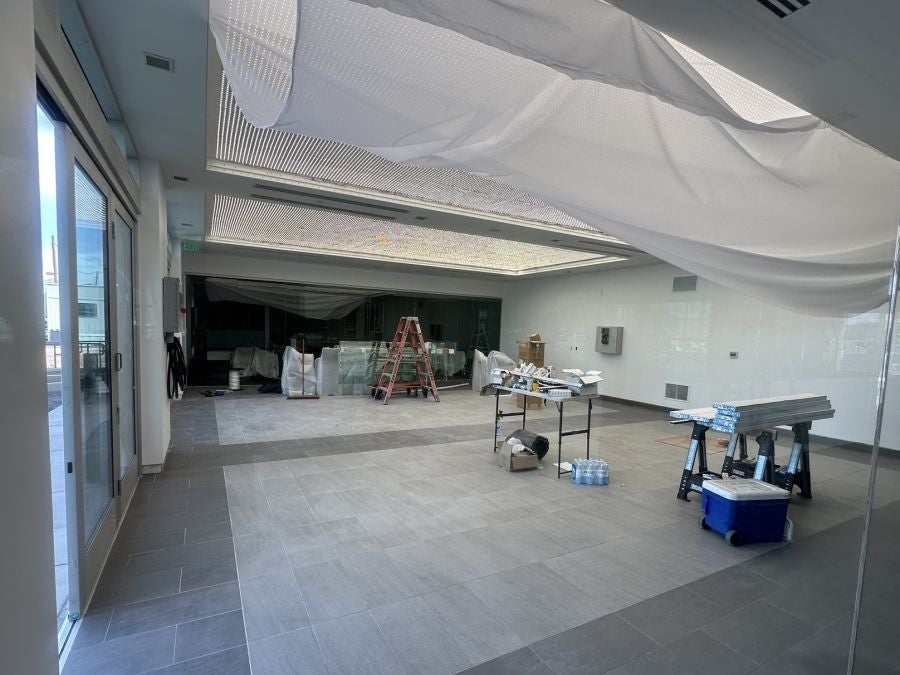 Open showroom floor at Earnhardt Cadillac with new tile and lighted ceiling panels