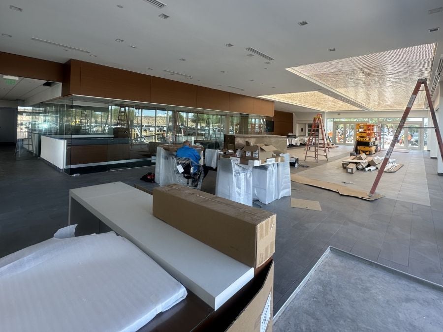 Earnhardt Cadillac showroom interior with glass offices and new lighted ceiling under construction